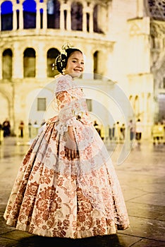 Portrait of a latina fallera girl wearing the traditional valencian costume of Fallas photo