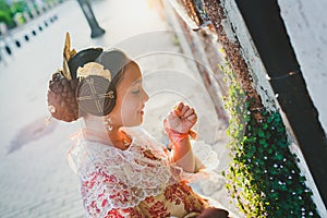 Portrait of a latina fallera girl wearing the traditional valencian costume of Fallas photo