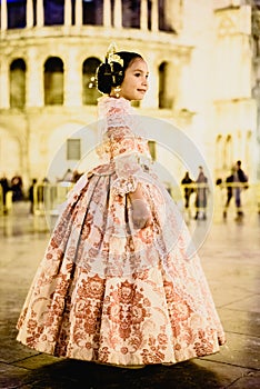 Portrait of a latina fallera girl wearing the traditional valencian costume of Fallas photo