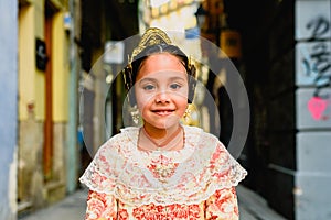 Portrait of a latina fallera girl wearing the traditional valencian costume of Fallas