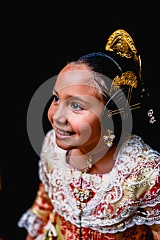 Portrait of a latina fallera girl wearing the traditional valencian costume of Fallas photo