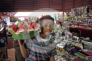 Portrait of Latino boy selling water melons