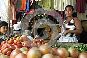 Portrait of Latino market vendor in vegetable stall