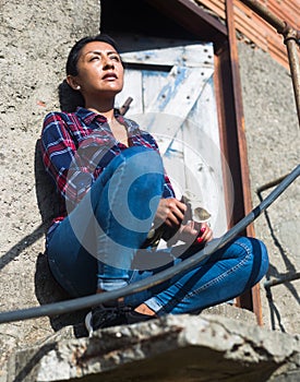 Portrait of latino woman on the porch of a house