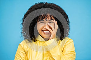 Portrait, laugh and funny with a black woman on a blue background, laughing at a joke in studio. Face, happy and smile