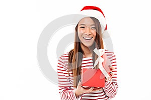 Portrait of a laughing asian girl in christmas hat