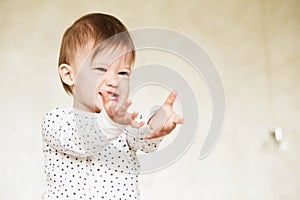 Portrait of a laughing baby girl in pajamas