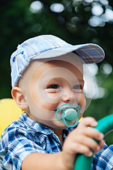 Portrait of a laughing baby with pacifier photo