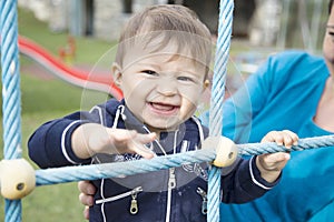 Portrait of laughing baby on playground