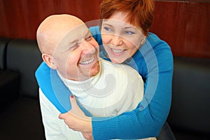 Portrait of laughing bald man and a red-haired