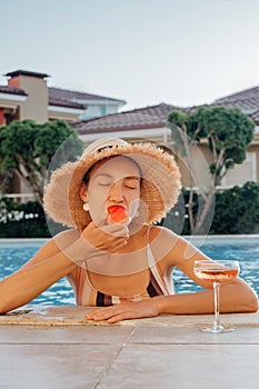 Portrait of laughing beautiful woman in swimwear relaxing in swimming spa pool
