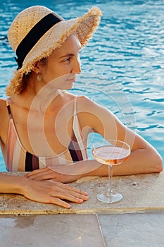Portrait of laughing beautiful woman in swimwear relaxing in swimming spa pool