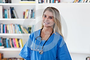 Portrait of laughing blond female nurse or doctor