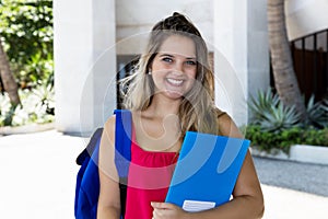 Portrait of a laughing blond female student