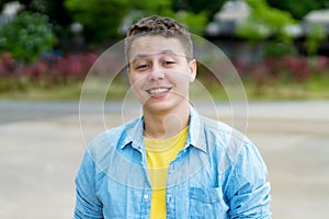 Portrait of laughing german young adult man outdoor in city