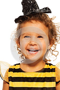Portrait of laughing girl in striped bee costume