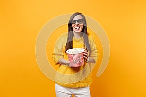 Portrait of laughing young girl in 3d imax glasses watching movie film, eat popcorn from bucket isolated on bright