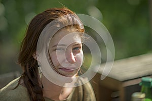 Portrait of a laughing young girl against blurred background