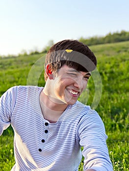 Portrait of a laughing young man outdoors