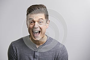 Portrait of a laughing young white man looking to camera