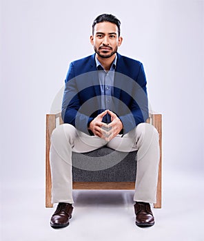 Portrait, lawyer and business man on chair in studio isolated on a white background mockup space. Professional, attorney