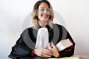 Portrait of lawyer woman sitting and holding red law book