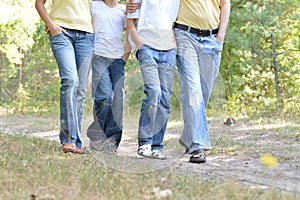 Portrait of legs of people walking on dirt road close up