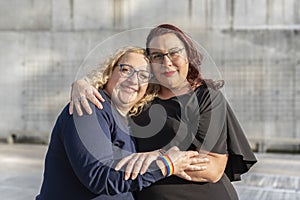 Portrait of a lesbian couple hugging each other outdoors