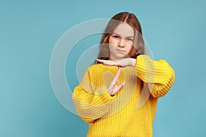 Portrait of little adorable girl showing timeout, child asking break with imploring expression.