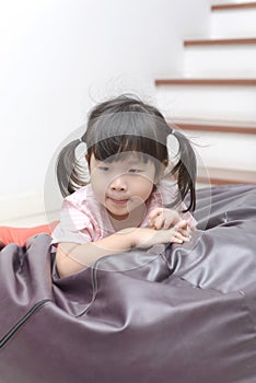 Portrait of little Asian child girl looks sad or in a suspicious mood