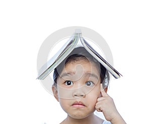 Portrait of little Asian child thinking and put a book on top