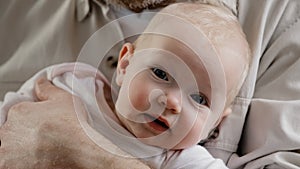 Portrait little baby girl cute small boy newborn blue-eyed child infant looking at camera. Unrecognizable father man