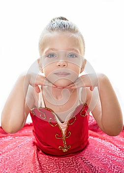 Portrait of a little ballerina in a pink dress and tutu looking at the camera, copy space. Smiling baby girl dreaming to become