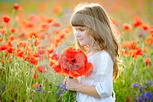 Portrait little beauty girl with wild flowers bouquet