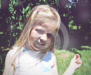 Portrait of a little blonde smiling girl; soft retro style