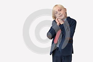 Portrait of a little boy in a business suit and red tie with copy space