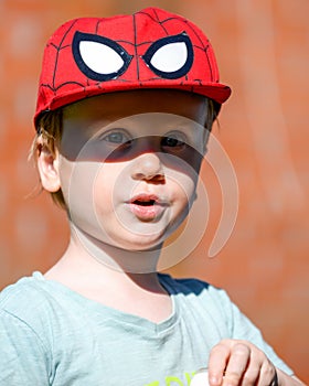 Portrait of a little boy with a cap on