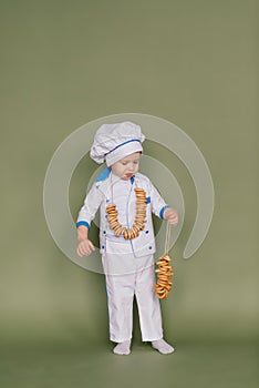 Portrait of a little boy cook at kitchen. Different occupations. Isolated over white background