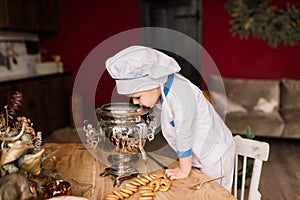 Portrait of a little boy cook at kitchen. Different occupations. Isolated over white background