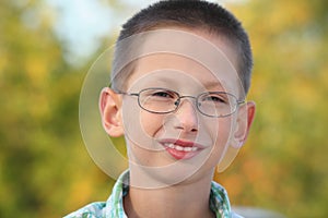 Portrait of little boy in early fall park.