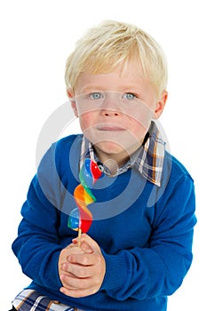 Portrait of a little boy eating a lolly