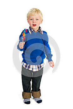 Portrait of a little boy eating a lolly