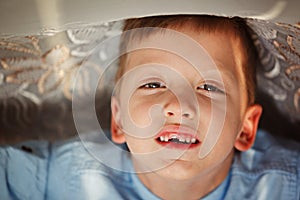 Portrait little boy in fall missing his first milk tooth.