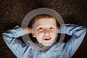 Portrait little boy in fall missing his first milk tooth.