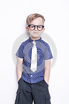 Portrait of a little boy in a funny glasses and tie. School. Preschool. Fashion. Studio portrait isolated over white background