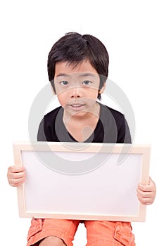 Portrait of a little boy holding a whiteboard