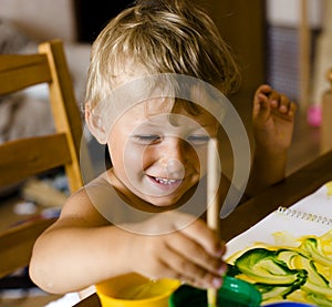 Portrait of little boy painting