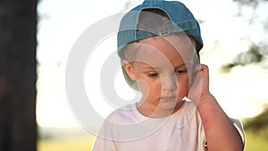 portrait of a little boy in the park. close-up of a boy in nature. happy family child concept. happy boy smiling