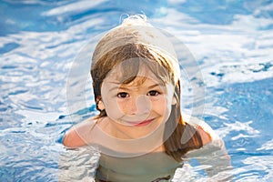 Portrait of little boy swim in sea. Kid laughing in water of waves at sea. Funny kids face.