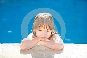 Portrait of little boy in swimming pool. Concept of kids face. Head shoot children portrait. Kid relax in pool side.